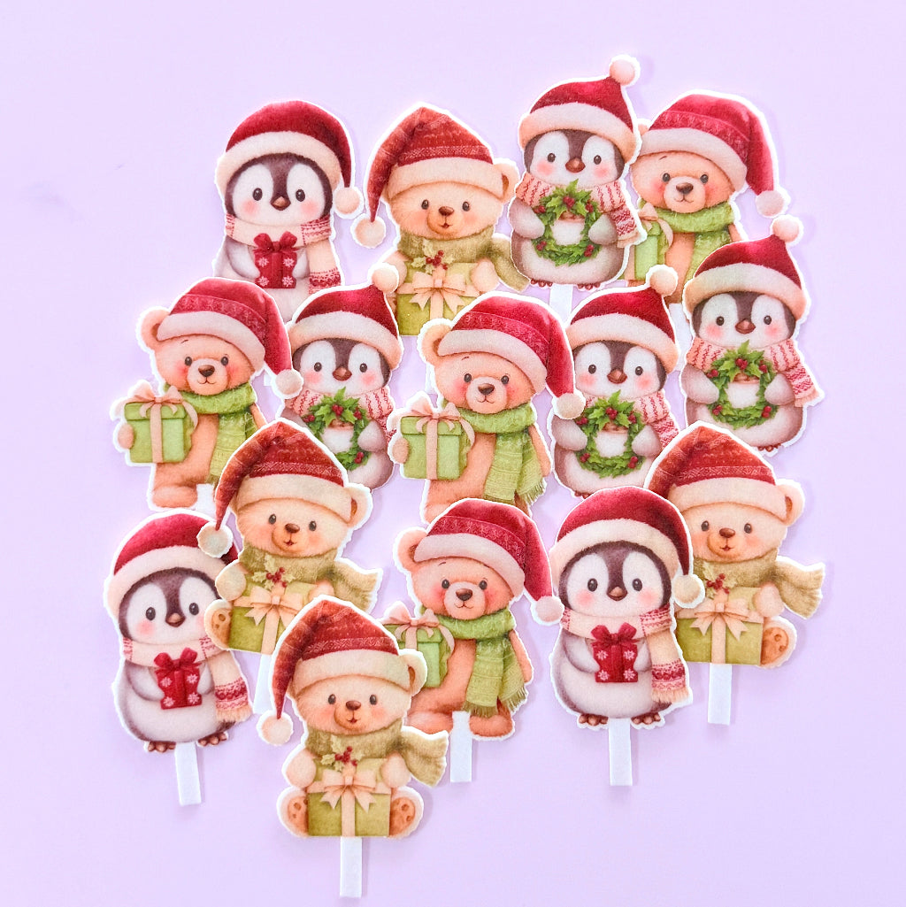 A set of cute cartoon penguin and teddy bear christmas wafer paper toppers on a light lavender background. Edible Wafer Card Cupcake Toppers - Christmas Bears and Penguins