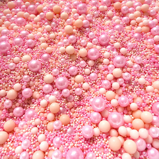 Pink and peach-colored round beads scattered together Edible Sprinkles - Blushing Peach 100g